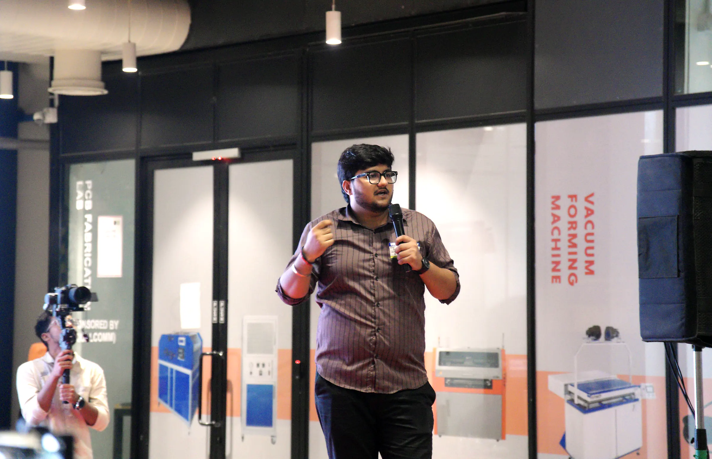 A founder presenting with a microphone in front of the audience