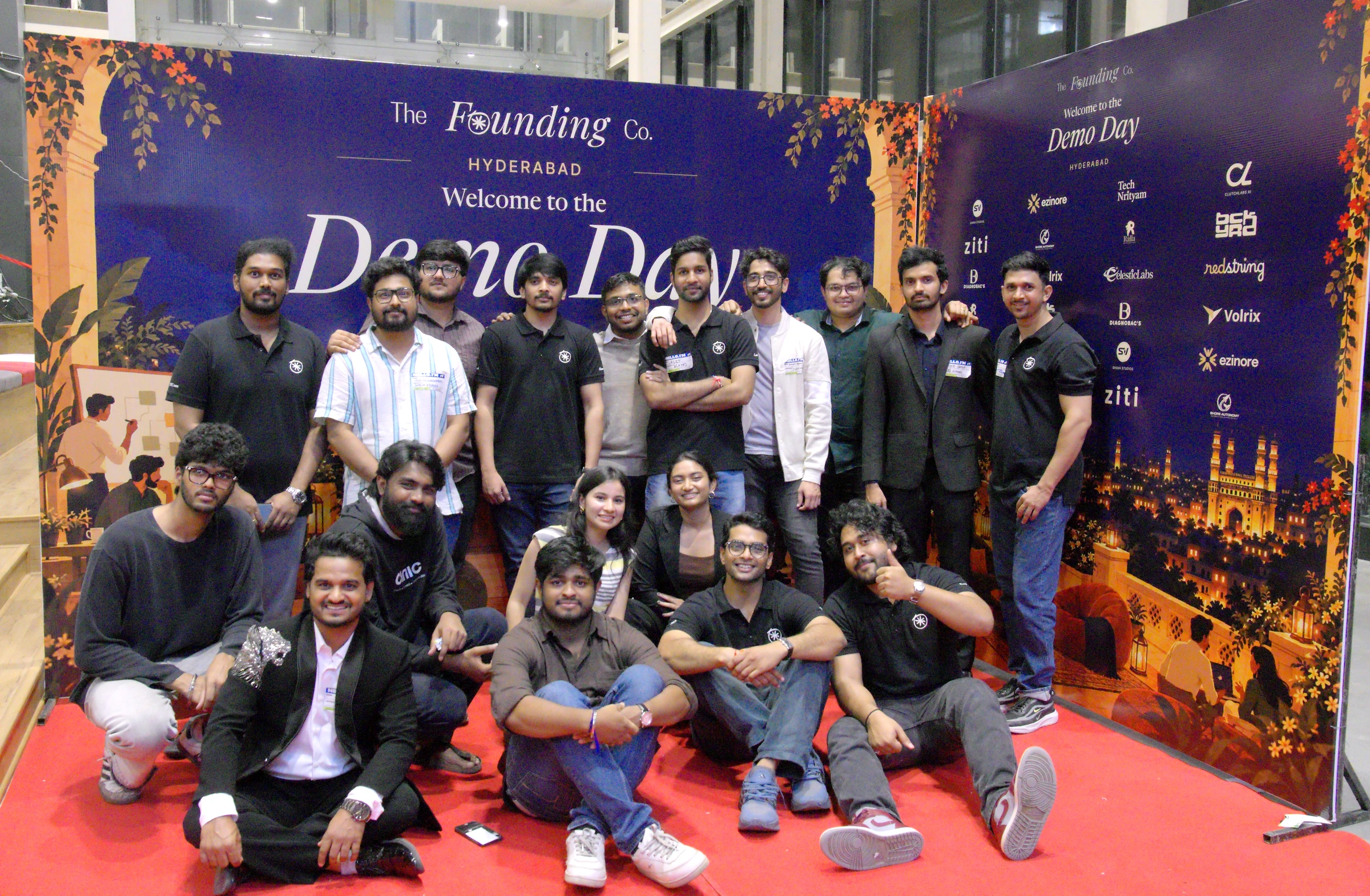Founders and the team together in front of The Founding Company backdrop at Demo Day