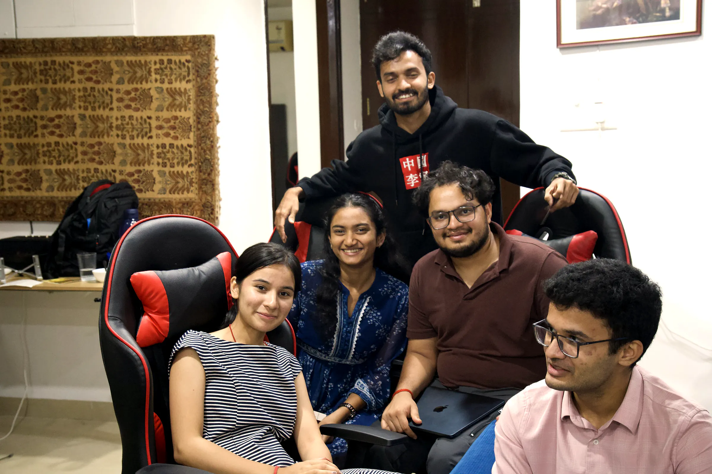 Founders and guests laughing together in the gaming chairs