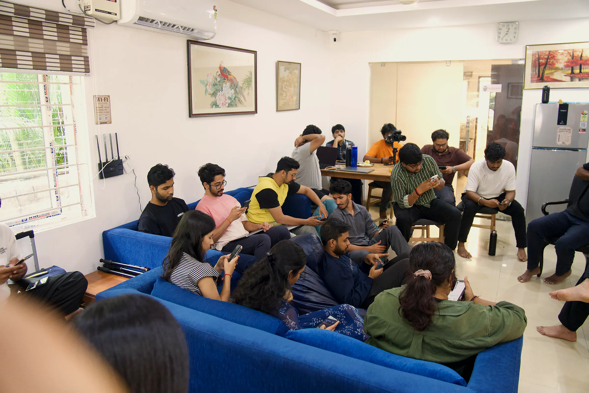 A packed living room listening to a guest session